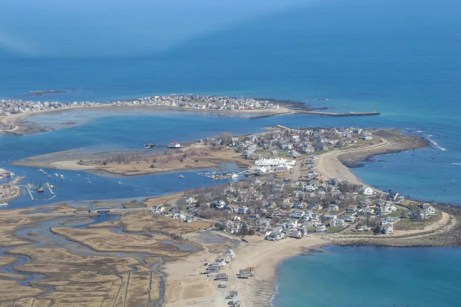 Aerial view of Cedar Point, Scituate Harbor and the lighthouse jetties from the north